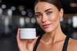 © BrandwayArt - Woman presenting white cream jar in Gym during daytime