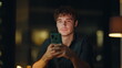 © stockbusters - Night manager reading sms at dark corporate workspace closeup. Smiling manager