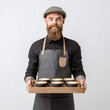 © krosdar - Young male barista with beard holding tray of takeaway coffee cups