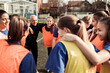 © Davor - Girls soccer team huddling with coach before game on outdoor field