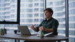 © stockbusters - Professional explaining strategy remotely talking to laptop webcam in office.