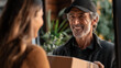 © Wasin Arsasoi - Prompt Delivery: A cheerful delivery person hands a package to a customer, symbolizing a friendly transaction and reliable service. captured an interaction, reliability, and service.