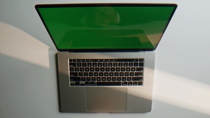 Wall Mural - Hand using mockup laptop button professional indoor workspace closeup top view