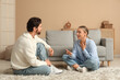 © Pixel-Shot - Young woman having dialogue with her husband at home