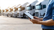 © SAN - Fleet Management Logistics Manager Using Tablet Inspecting Trucks in a Transportation Hub