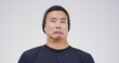 © peopleimages.com - Comic, funny face and portrait with man on studio space for emotions, humor or silly joke. Comedy, emoji and unique with goofy Asian person isolated on white background for crazy or quirky reaction