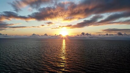 Wall Mural - arafed view of a sunset over the ocean with clouds