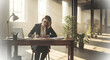 © Hendriawan - Businesswoman Writing at Desk in Loft Office.