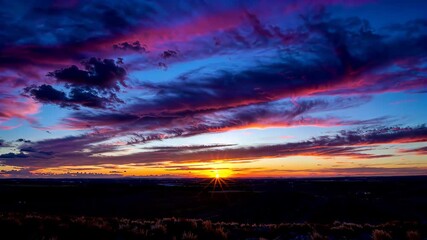 Wall Mural - arafed view of a sunset over a field with a few clouds