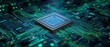 © Nina - The intricacies of a microchip on a green and blue circuit board.
