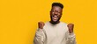 © Kovalenko - The joyful man celebrating success with enthusiasm against a bright background.