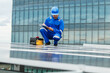 © DG PhotoStock - Electrical engineer inspecting and installing a solar panels on the building rooftop.