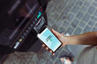 © Przemek Klos - Woman paying for parking ticket using phone. Electronic payments. NFC technology. Fast mobile payments. Convenience and security