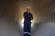 © eakarat - A male mechanical engineer in safety uniform is inspecting and examining a piping system for a new construction project of a large industrial building.