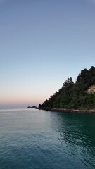 Wall Mural - sunrise on the coast with calm, rolling waves
