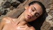 © Uncle-Ice - Young woman nude model with beautiful face and wet hair and skin lying on rock
