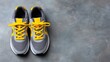 © pinporn manosri - Pair of gym training shoes on concrete background with copy space and overhead view