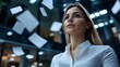 © Undersea - Young professional woman in white business attire looking up confidently against modern office background with floating papers, representing success and aspirational career goals.