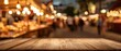 © Studio Nova - The wooden table in front of a vibrant market scene with bokeh lights.