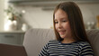 © Yuliia - Caucasian little girl learner schoolgirl child kid offspring daughter using laptop pc computer desktop educate study smile pleasure communication online internet chatting sms technology gadget network