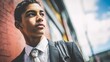 © QuietWord - young black African American teenager boy in business attire look smart and confident at city street