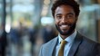 © Bussakon - A smiling professional in a business portrait  long title A friendly confident looking man in a suit and tie providing a welcoming and professional