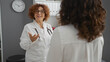 © Krakenimages.com - Doctor woman consulting patient in a hospital room highlighting healthcare and communication, featuring two adult hispanic women in a clinical interior setting
