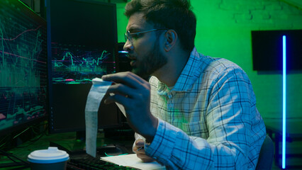 Arabian Indian man male guy programmer examining writing binary code coder freelancer engineer worker IT specialist monitor analyzing computer ecommerce office business hacker businessman Bitcoin web