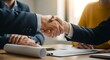 © PixMix - Business deal happens as partners shake hands over documents, cementing a new agreement and promising future collaboration between involved parties.