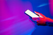 © ADDICTIVE STOCK - Hand using smartphone under neon lights