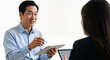 © DEGE - A focused male executive discusses a business strategy with a colleague over a tablet in an office setting on an isolated background