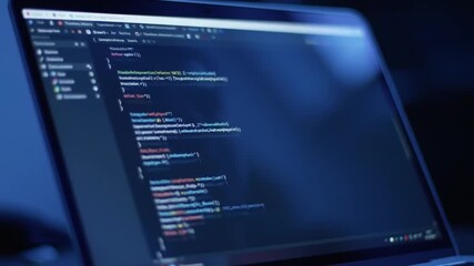 Laptop Screen Displaying Code in Blue Light Software Development Technology
