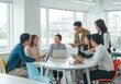 © Rosie Lee - Diverse team collaborating effectively in a modern office environment discussing business strategies