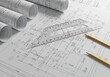 © Vector_Teacher - Engineer's workspace with blueprints, a set square, and pencils, illustrating the detailed planning and creation process