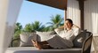 © narumiaegis - Serene Woman in Robe Relaxing on a Balcony, Embracing a Peaceful Morning and the Beauty of Tropical Scenery