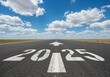 © Smartra - The year 2025 painted on an asphalt runway with an arrow pointing forward