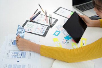 Female ux developer and ui designer , mobile app interface wireframe design. App developer working about screen display prototype layout for smartphone, ui, ux concept.