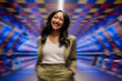 © Westend61 - Confident businesswoman smiling in a colorful urban tunnel
