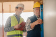 © Ljustina - Construction workers using spirit level and taking notes on building site