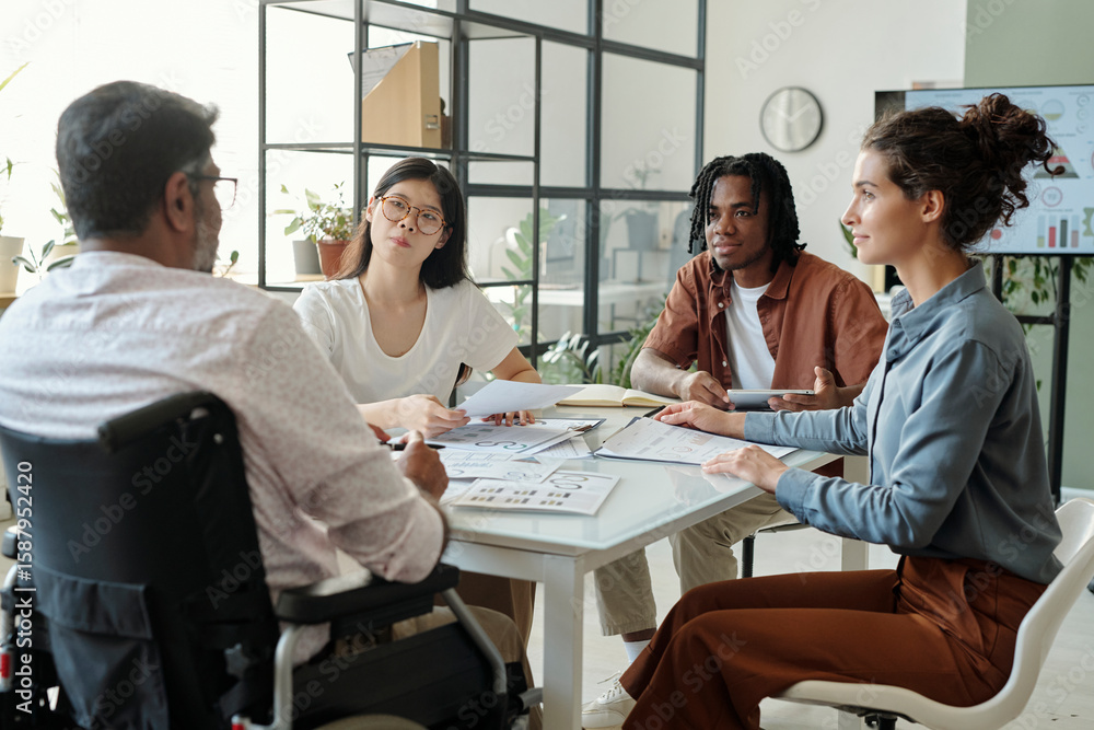 Inclusive team meeting in a modern office setting with a focus on ...