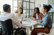 © Westend61 - Inclusive team meeting in a modern office setting with a focus on collaboration and diversity