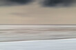 © Mint Images - Blurred motion abstract seascape at dusk with grey clouds and faint pink light