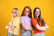 © New Africa - Beautiful women with different hair colors wearing stylish sunglasses on orange background