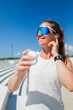 © muse studio - Joyful athlete enjoying music under blue skies while preparing for workout