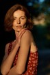 © Michael Shifrin - A beautiful woman with red hair and freckles in a red floral dress