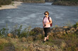 © Ольга Калинчук - female tourist walking with backpack on beach and rocks