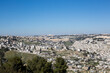 © Olga Mazo - Panoramic view of Jerusalem, Israel with the historic Old City, Dome of the Rock, and surrounding residential neighborhoods under clear blue sky.