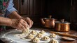 © misu - Close up of hands crafting khinkali, a traditional Georgian dumpling, ready for cooking in a rustic kitchen.