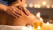 © taa - Hands Massaging Oil Into The Shoulder Of A Relaxed Person with Candlelight Background