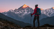© ElenPI_K - Woman hiking in mountains at sunrise with snow-capped peaks